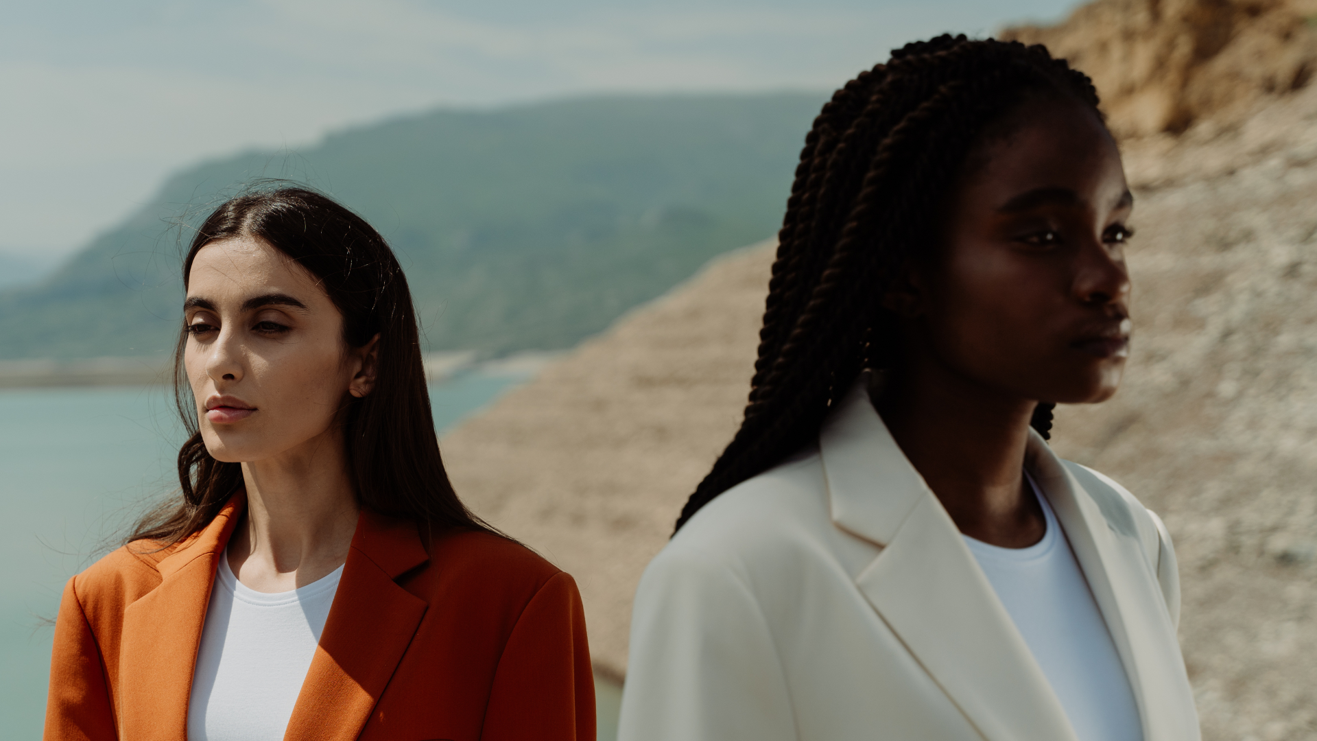 Two women in stylish blazers showcasing different color palettes